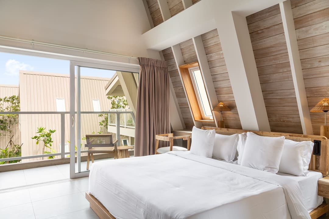 Wide bedroom with two beds and A-frame ceiling at Asaya Sands, Mirissa, Sri Lanka