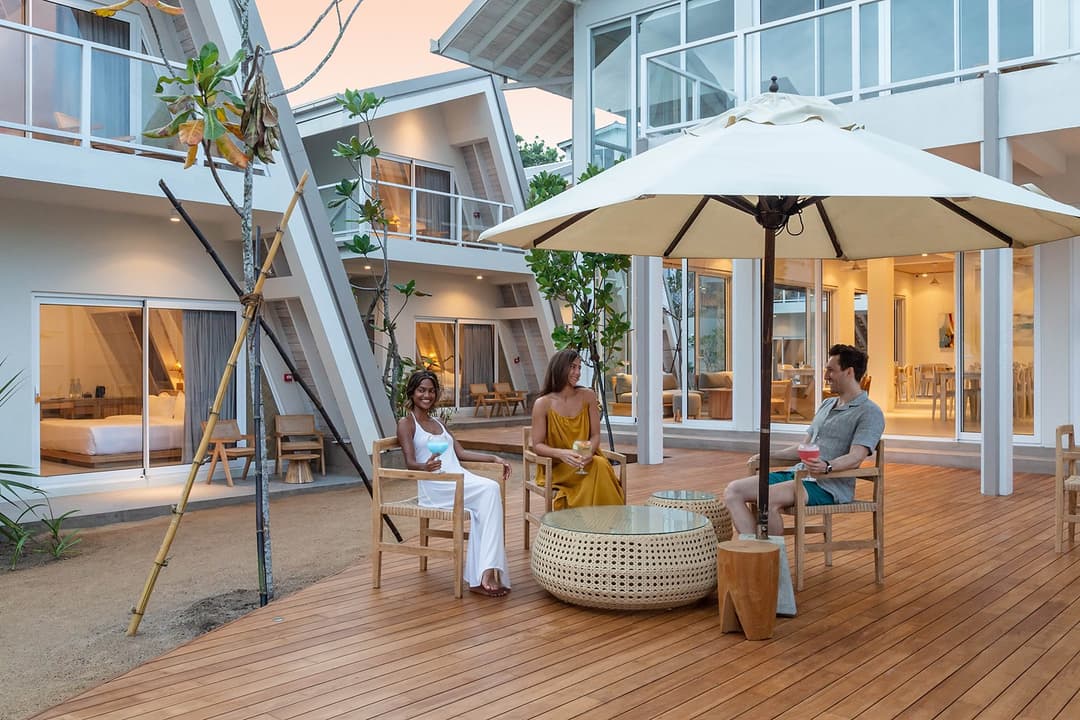 Asaya Sands Mirissa pool with umbrella and guest seated, Mirissa, Sri Lanka