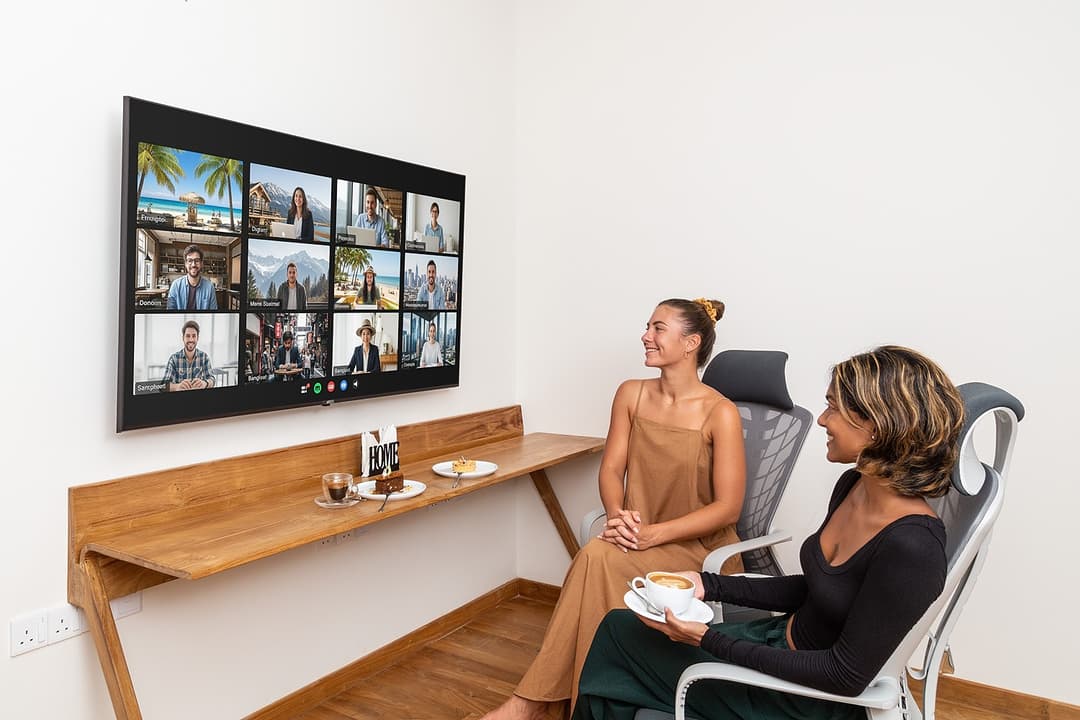 Two guests co-working with video call on TV at Asaya Sands, Mirissa, Sri Lanka