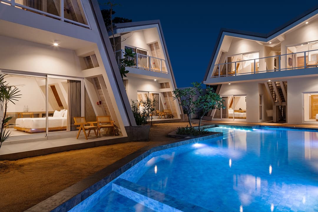 Asaya Sands Mirissa pool at night with lit A-frame chalets, Mirissa, Sri Lanka