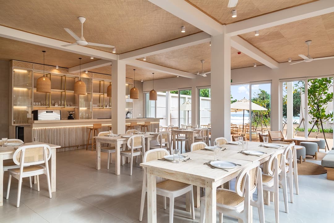 Wide restaurant with white chairs and ocean-facing view at Asaya Sands, Mirissa, Sri Lanka