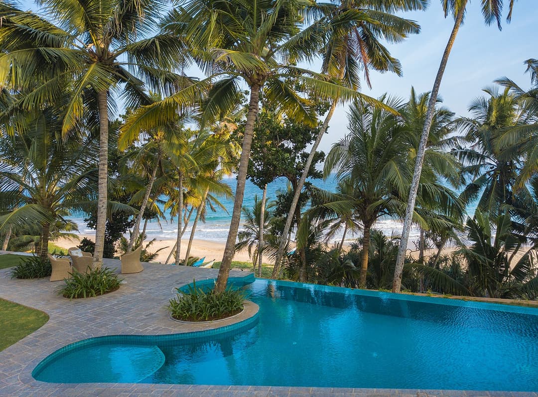 Aerial view of Abiman pool, palm canopy and beach beyond, Dickwella, Sri Lanka