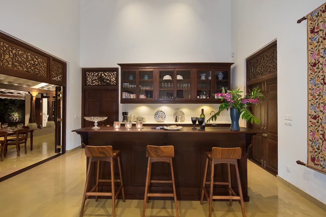 Bar and kitchen interior with timber shelving warmly lit at Abiman, Dickwella