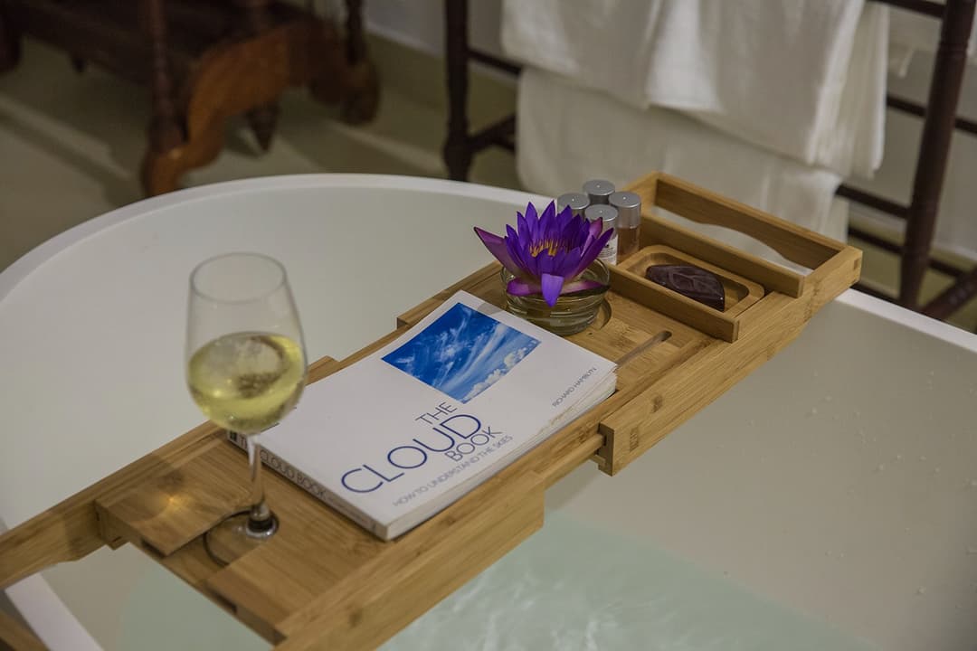 Bathtub tray with wine glass, book and flower at Abiman, Dickwella, Sri Lanka