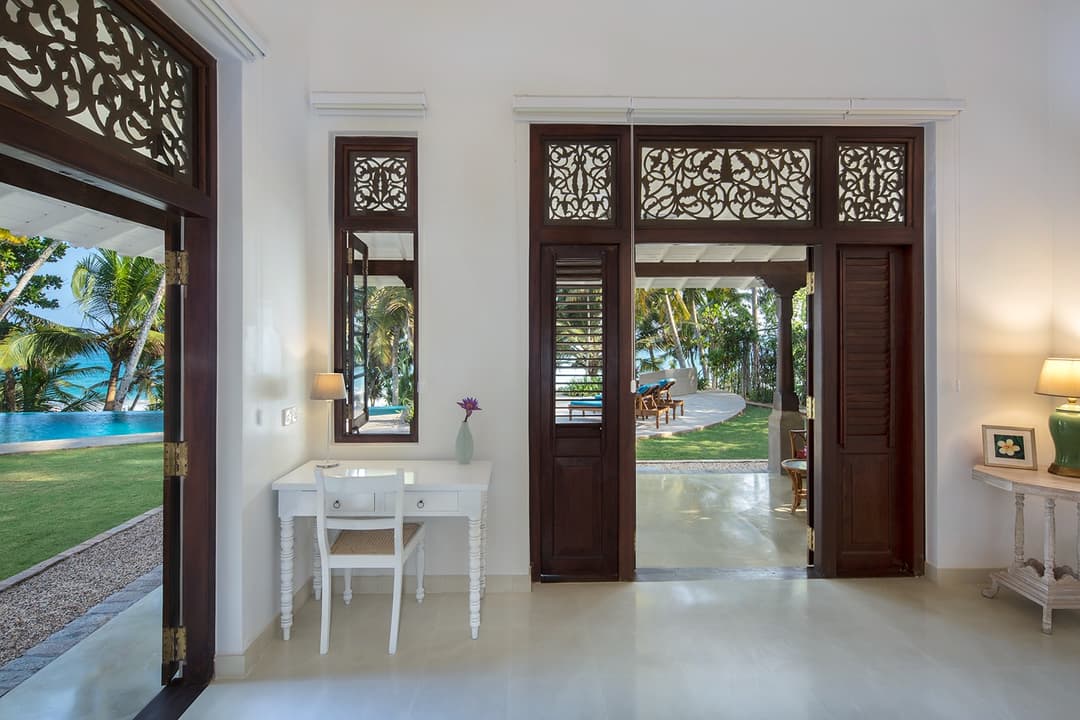Bedroom with double doors open to sea view at Abiman, Dickwella, Sri Lanka