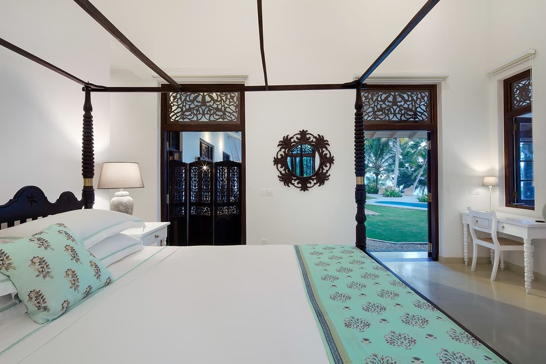 Four-poster bedroom with decorative screen and open veranda at Abiman, Dickwella