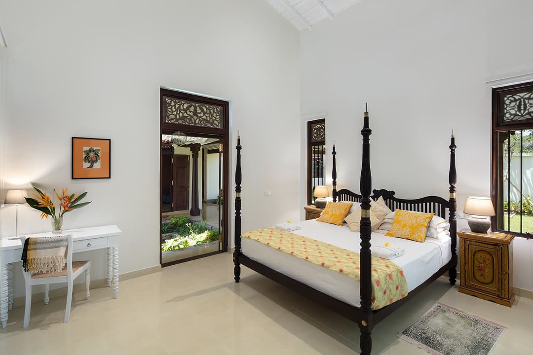 Four-poster king bedroom open to garden and sea at Abiman, Dickwella, Sri Lanka