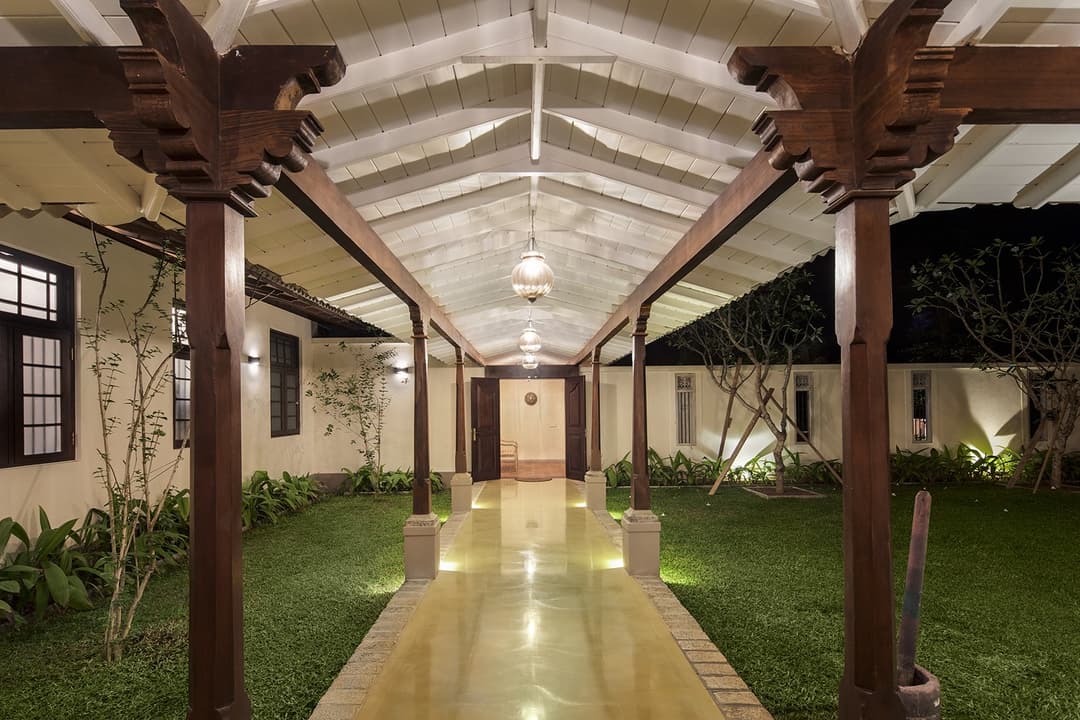 Colonnaded walkway between garden and villa buildings at Abiman, Dickwella, Sri Lanka