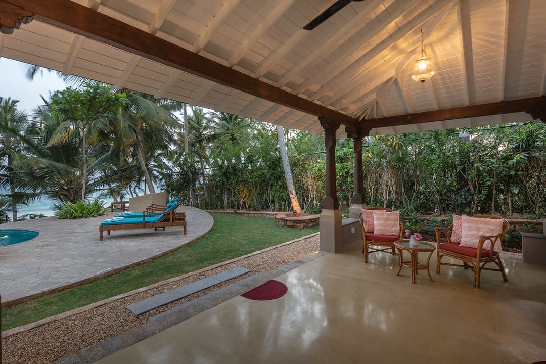 Covered outdoor dining and seating area with ocean view at Abiman, Dickwella