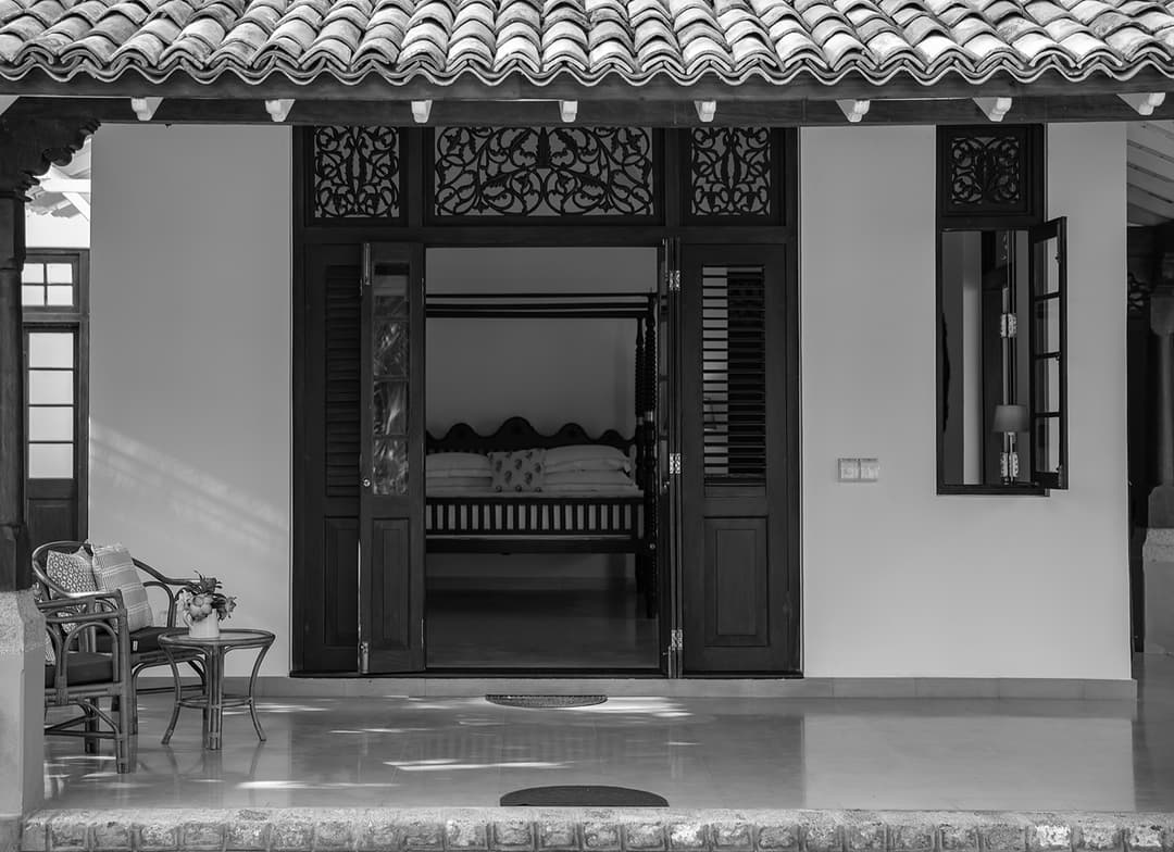 Entrance pavilion with ornate carved dark timber screens at Abiman, Dickwella