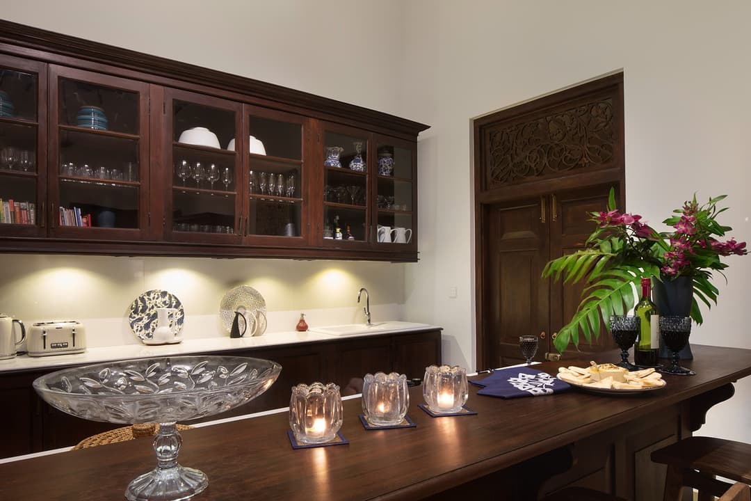 Interior bar and dining with dark timber shelving and flowers, Abiman Dickwella