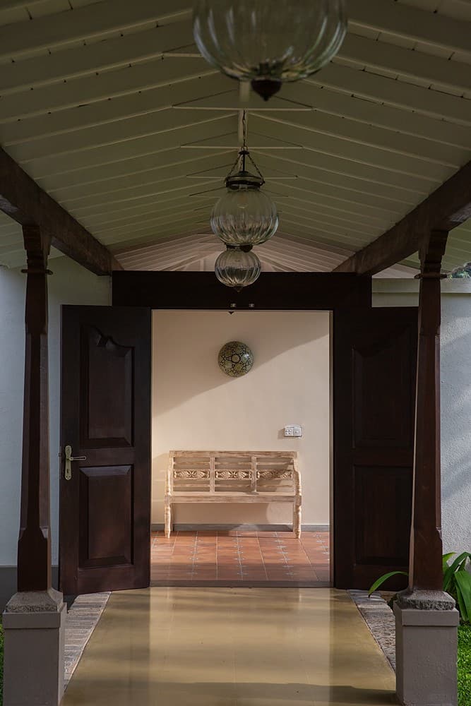 Interior entrance corridor with dark timber doors at Abiman, Dickwella, Sri Lanka