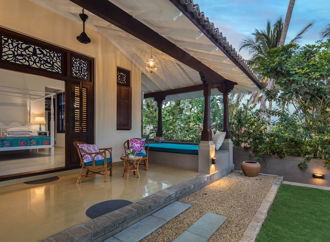 Open living pavilion with carved screens looking to ocean at Abiman, Dickwella
