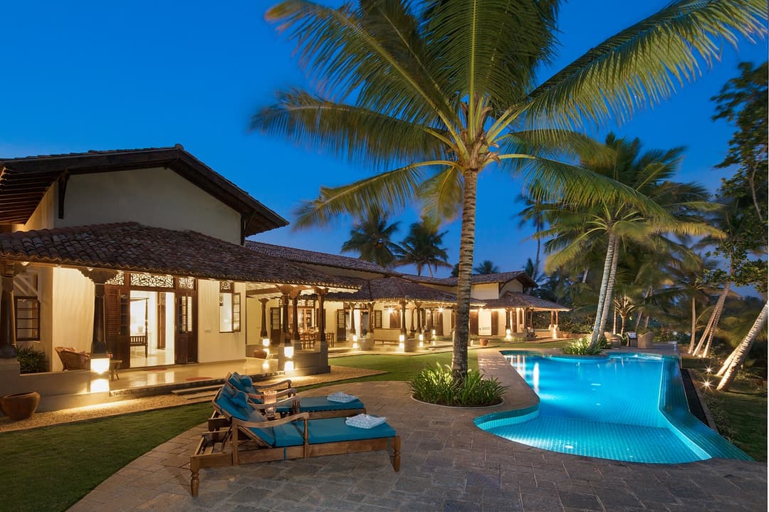 Abiman Dickwella pool and villa at blue hour with lit palms, Dickwella, Sri Lanka