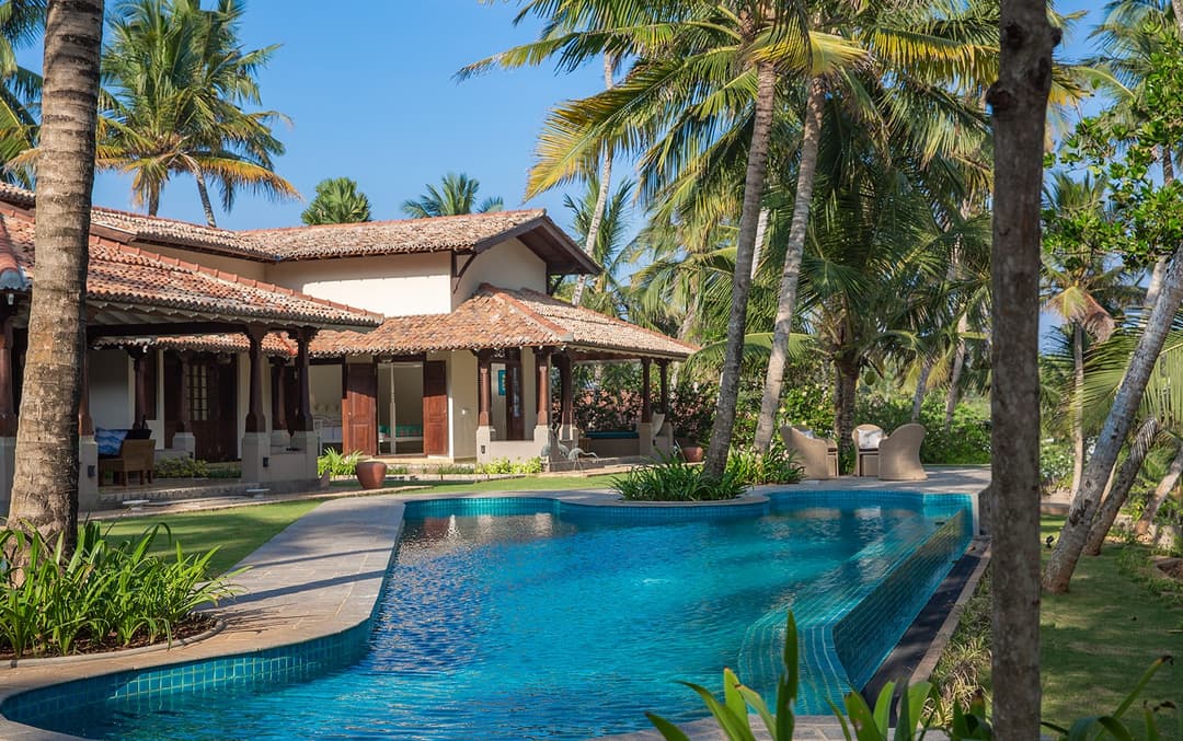 Abiman Dickwella salt-water infinity pool with villa and palms, Dickwella, Sri Lanka