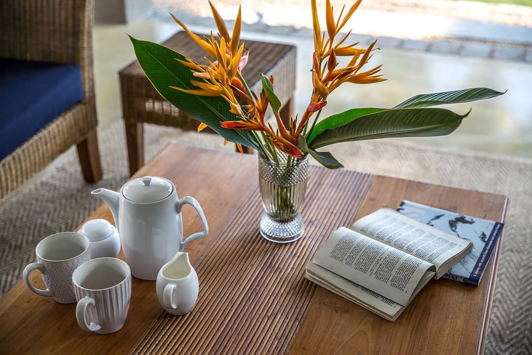 Terrace detail with flowers in vase and books at Abiman, Dickwella, Sri Lanka