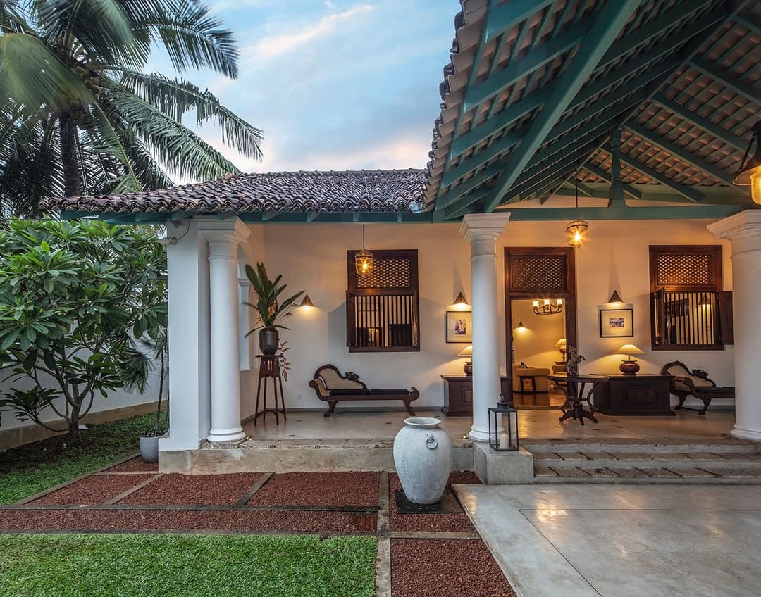 Villa exterior with columns at dusk, Magalla Casa Galle