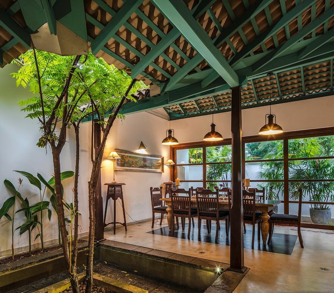 Dining area under tiled ceiling with pendant lights, Magalla Casa
