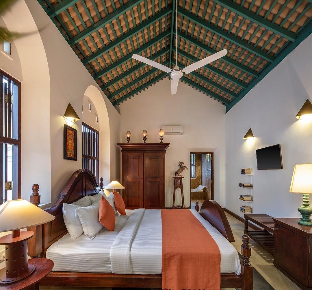 Bedroom one with orange bed wide view, Magalla Casa Galle