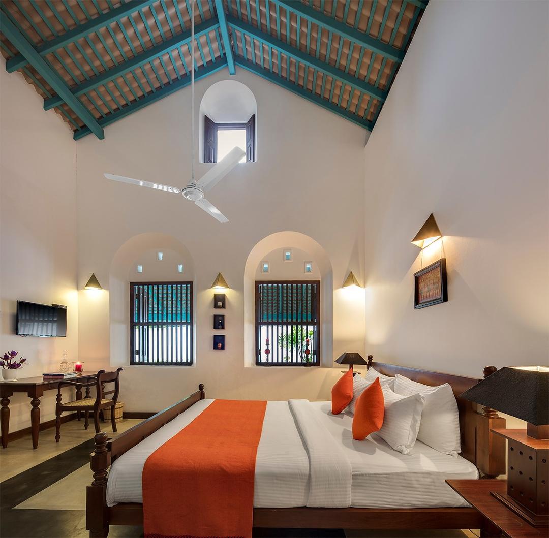 Bedroom with arched window and lamp, Magalla Casa Galle