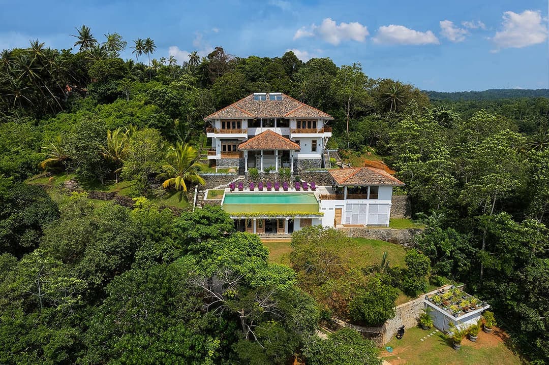 Aerial daytime view over paddy and forest, Divine Villa Talpe