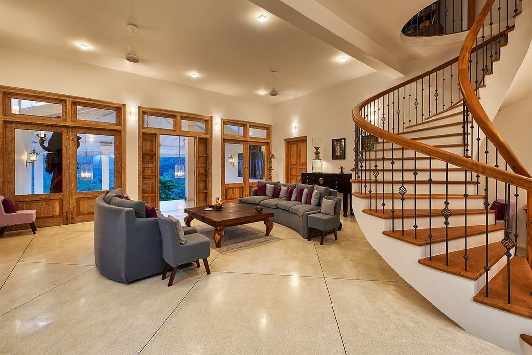 Living area with spiral staircase, The Divine Villa Talpe