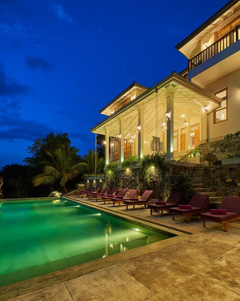 Pool deck lit at night wide angle, The Divine Villa Talpe