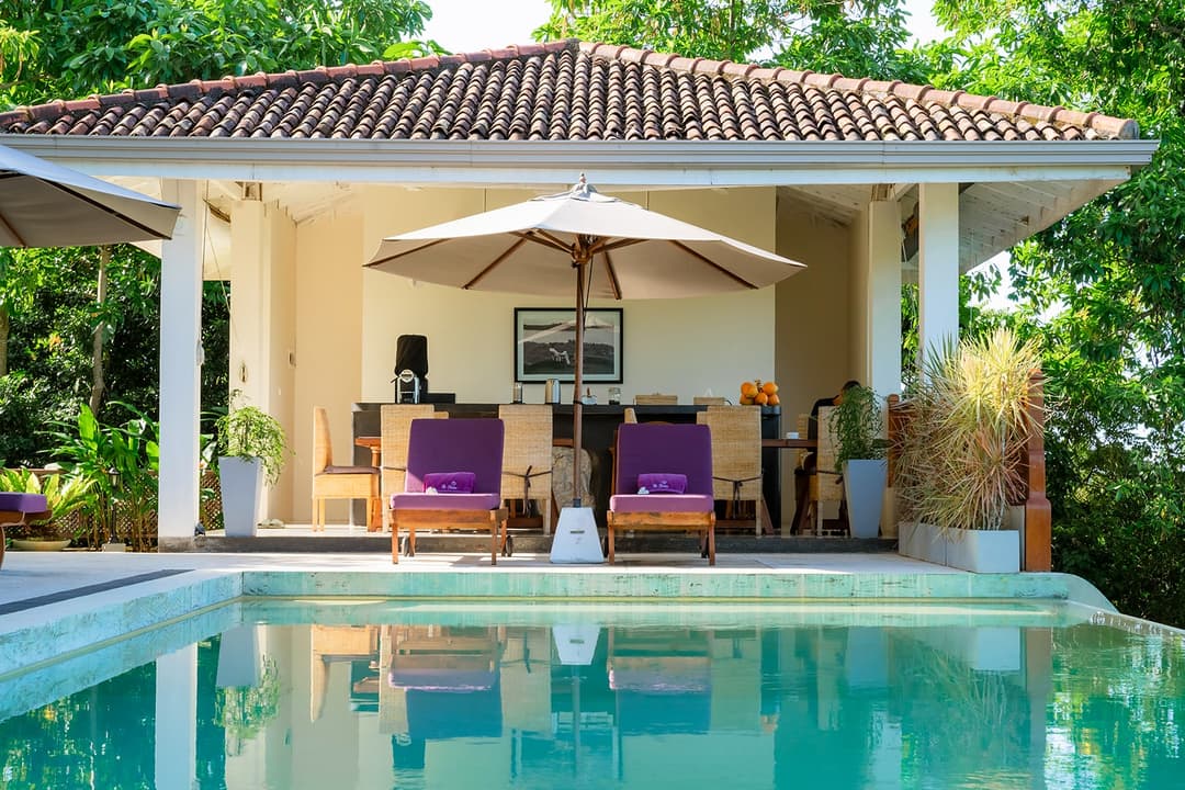 Pool deck umbrella and loungers close, Divine Villa Talpe