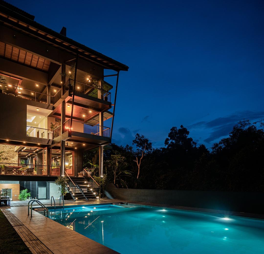 Villa exterior lit at night with pool, Kurokawa Kalutara