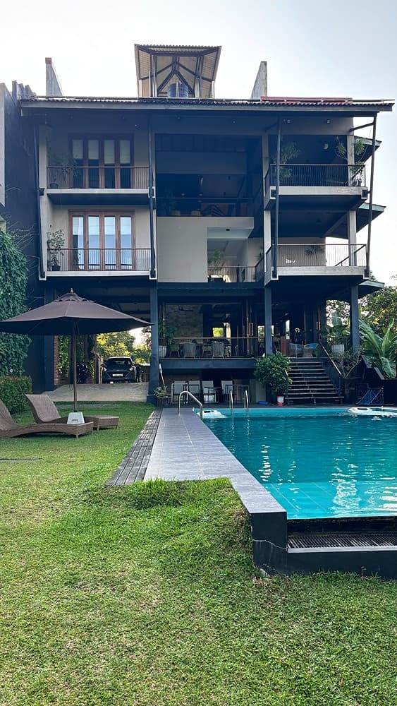 Villa exterior daytime with pool and lawn, Kurokawa Kalutara
