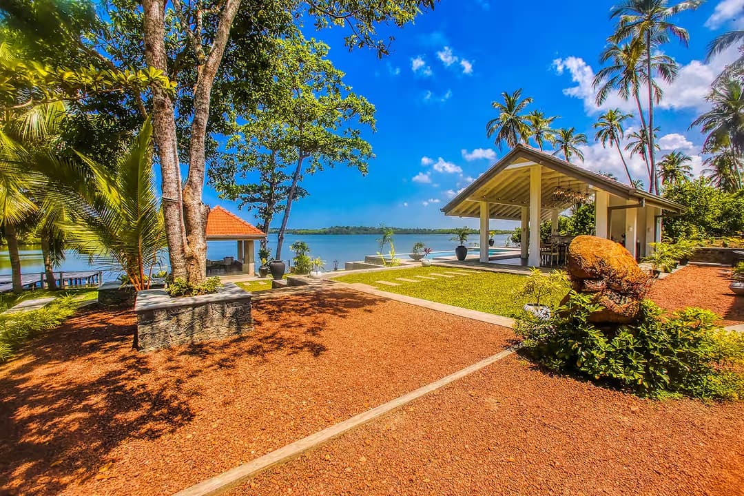 Garden path with palms and red earth, Niche Hikkaduwa