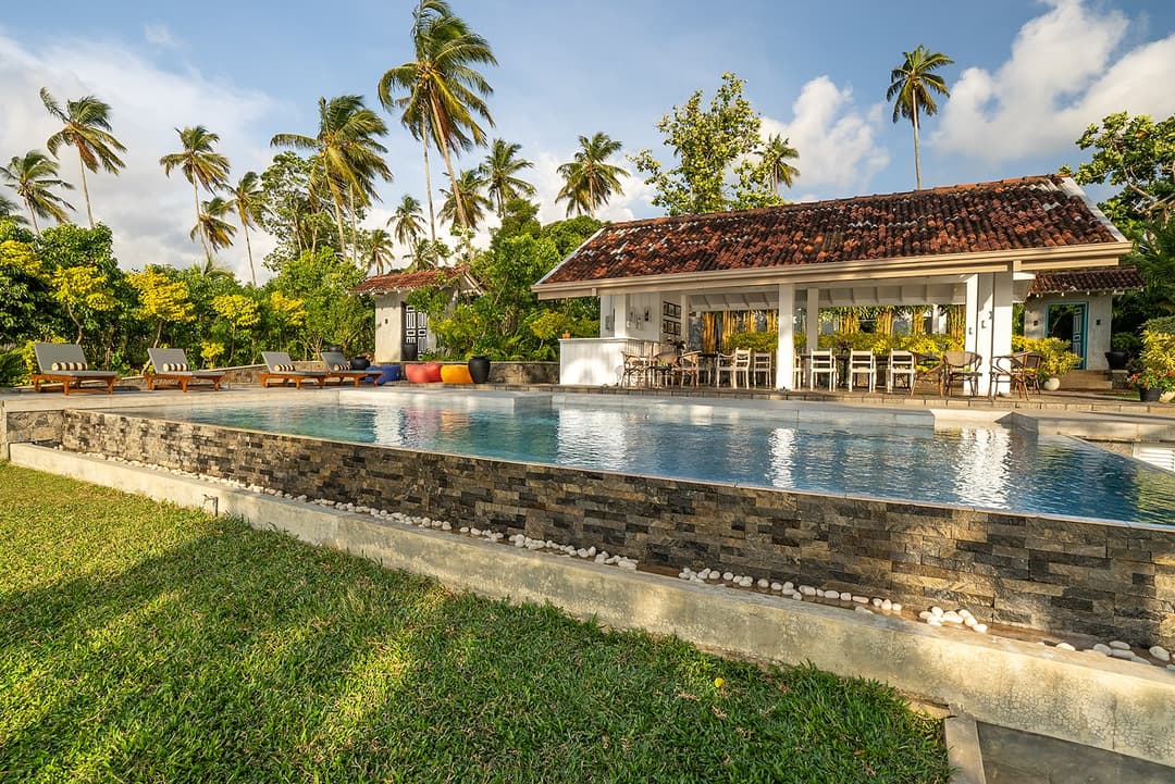 Long pool with villa and palms, The Niche Hikkaduwa