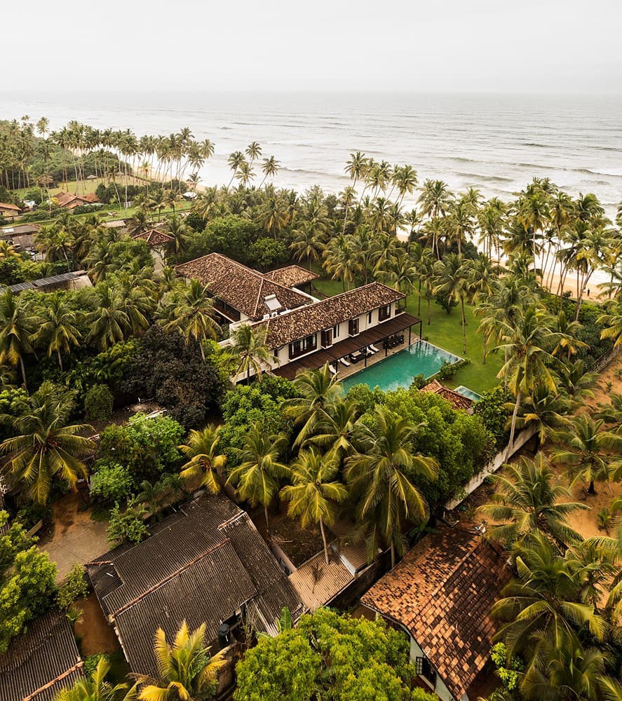 Aerial villa surrounded by palms, The Villa by CC Wadduwa