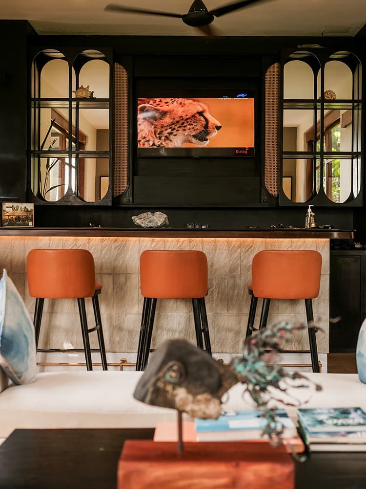 Bar interior dark with orange stools, Villa by CC Wadduwa