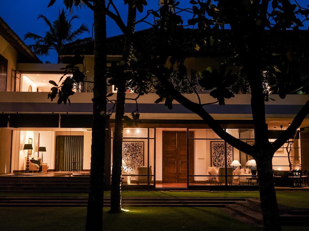 Villa exterior at dusk through trees, Villa by CC Wadduwa