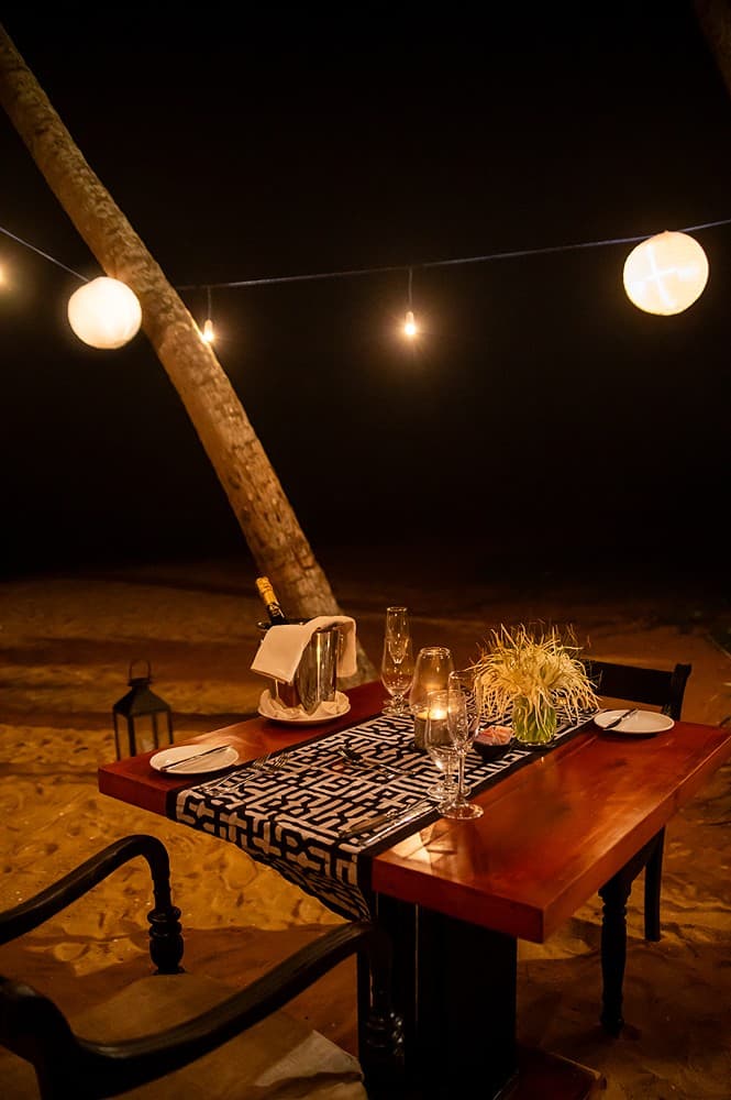 Outdoor dining at night with candles, Villa by CC Wadduwa