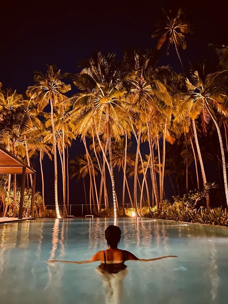 Guest swimming in pool at night, The Villa by CC Wadduwa