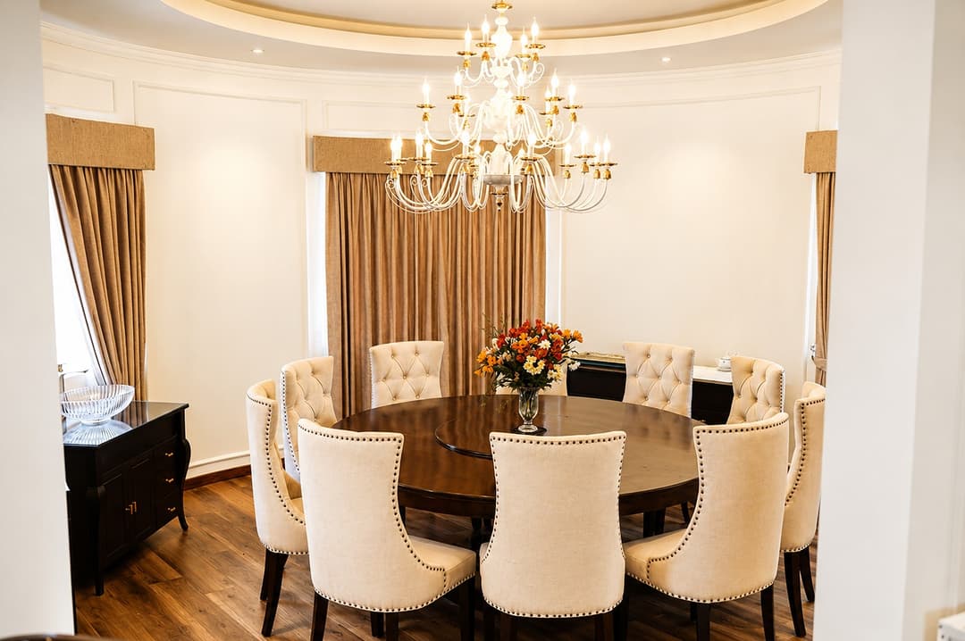Dining room with chandelier and oval table, The Mystique
