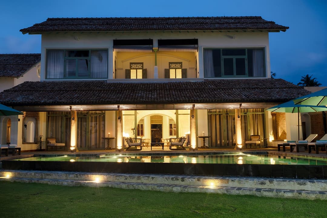 Villa exterior lit at night, Candella House Talpe
