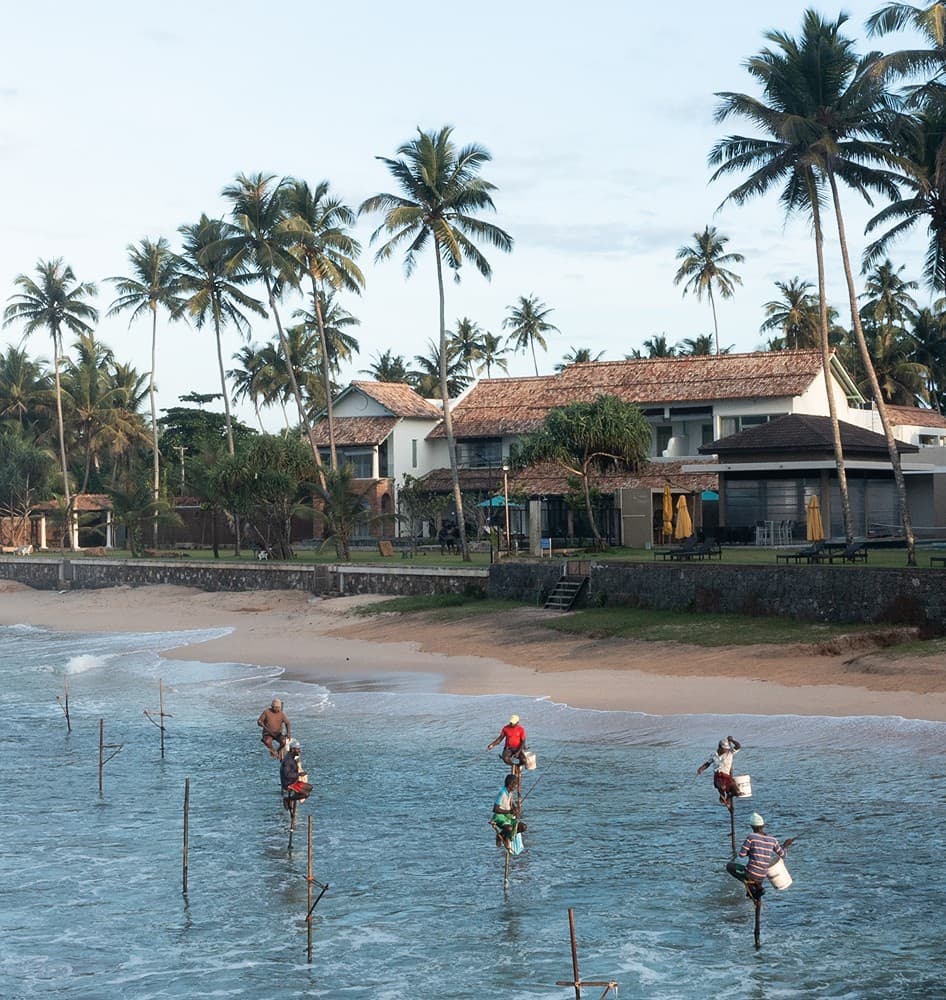 Stilt fishermen on beach aerial, Candella House Talpe