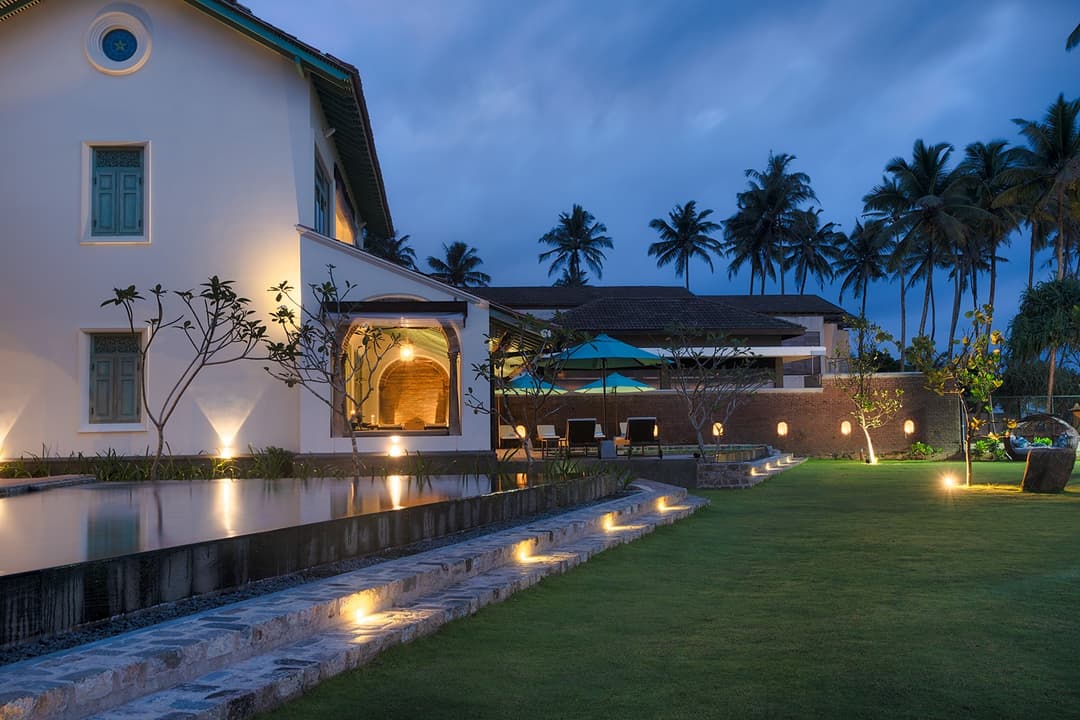Outdoor villa lit at night, Candella House Talpe