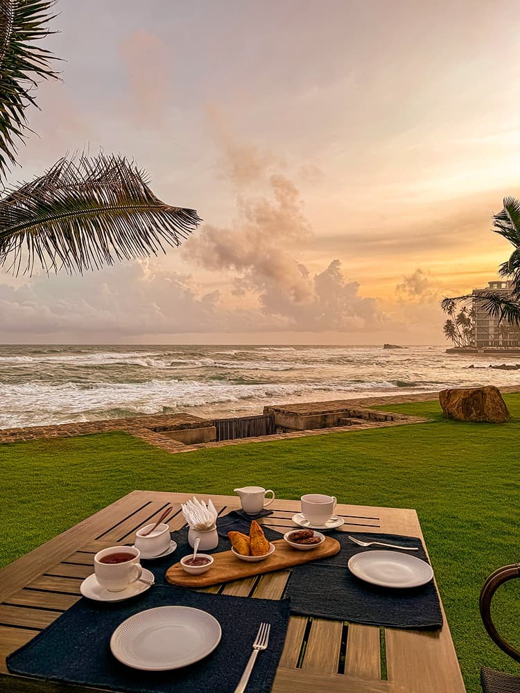 Outdoor dining at sunset on beach, Candella House Talpe