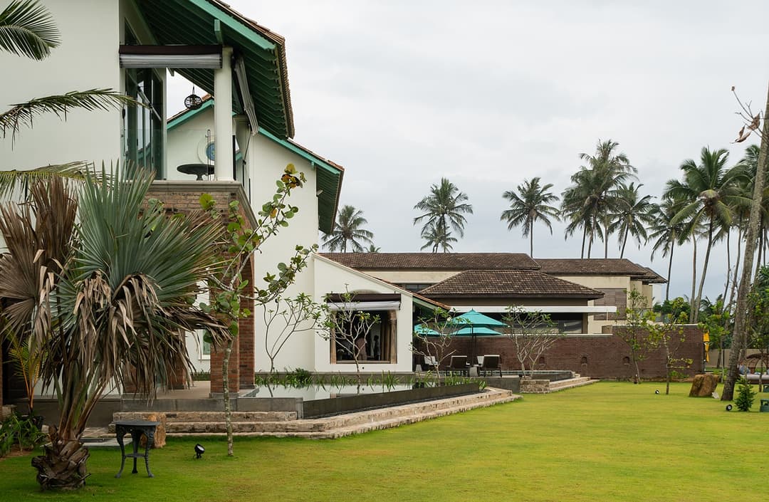 Garden lawn with palms exterior, Candella House Talpe