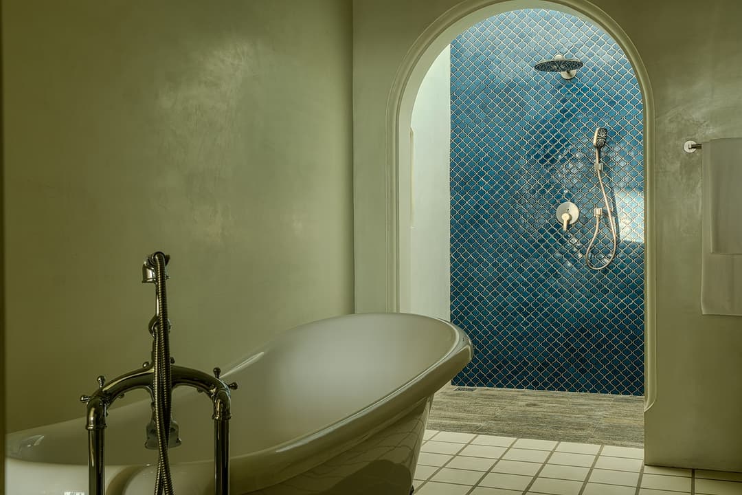Bathroom with tub and blue tiles, Candella House Talpe