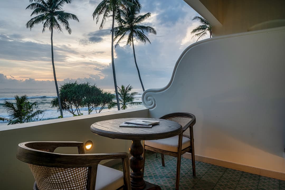 Balcony with ocean view and table, Candella House Talpe