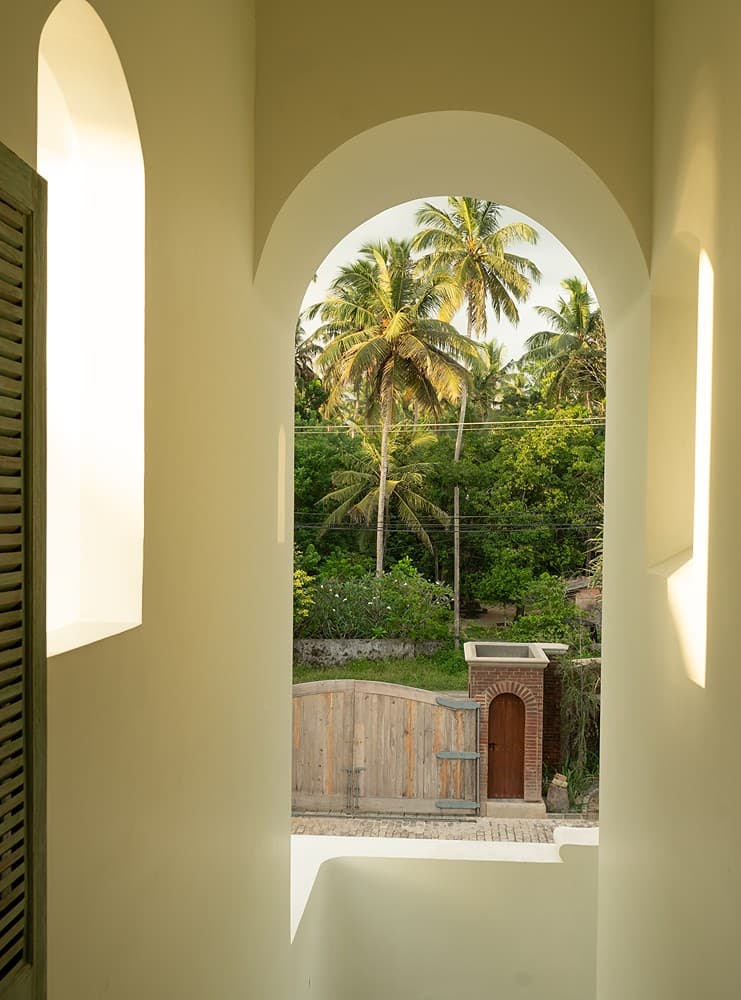 Arched doorway with palms view, Candella House Talpe