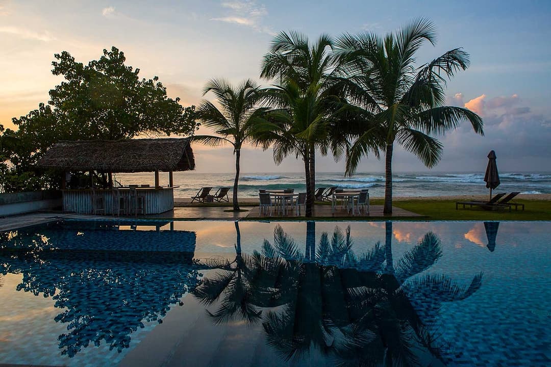 Sunrise aerial pool and beach, Sri Sharavi Mirissa
