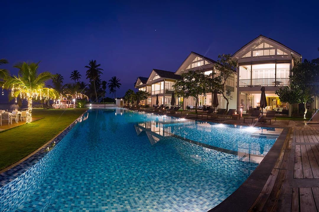 Villas at night with lit pool, Sri Sharavi Mirissa