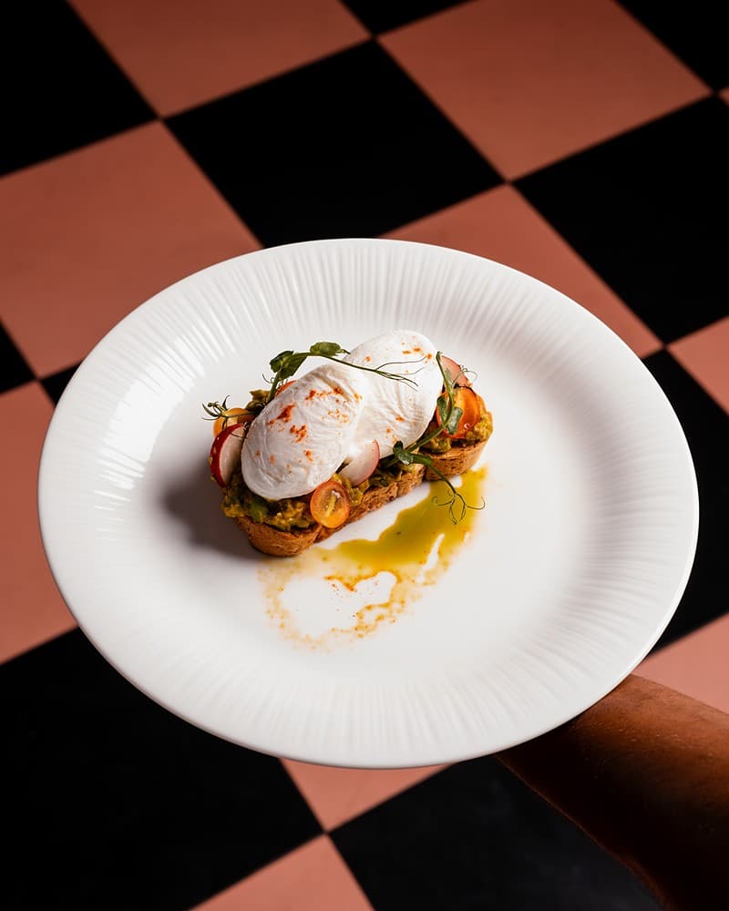 Eggs benedict on checkered surface, Padmaraga Galle Fort