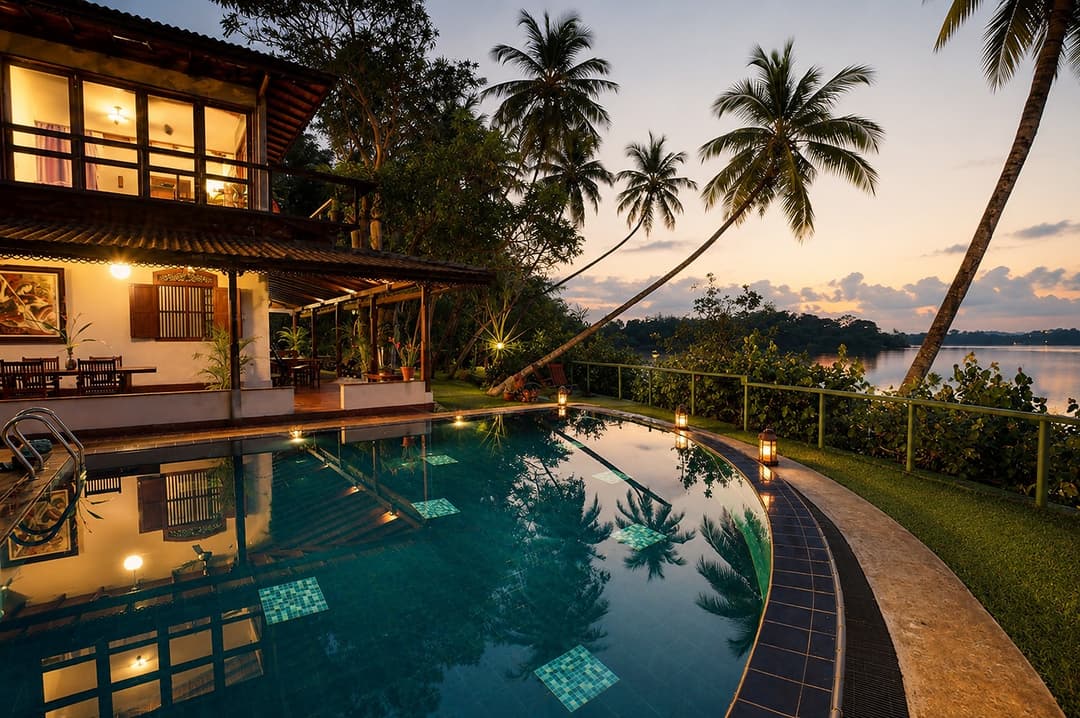Kingfisher House Koggala pool exterior lit at dusk